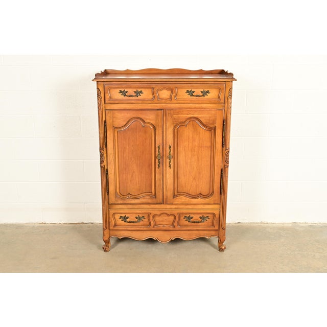 A beautiful French Provincial Louis XV style highboy dresser or chest of drawers By Fancher Furniture USA, Circa 1940s...