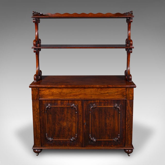 This is a large antique buffet server. An English, mahogany side cabinet with display tiers, dating to the early Victorian...