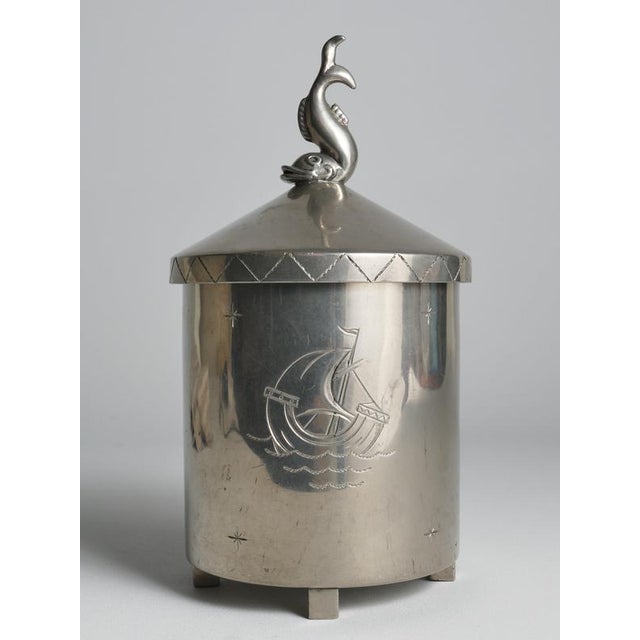 This exquisite Swedish pewter lidded vessel—originally conceived as a tobacco jar is a masterful example of early 20th-...