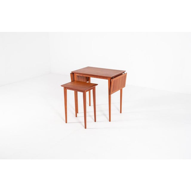 This is a beautiful vintage Scandinavian nesting table set made of warm-toned wood. The design is practical and stylish,...
