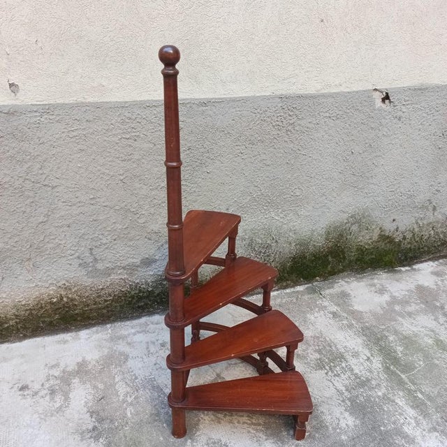 Small, unobtrusive four-step library ladder mounted in a spiral pattern on a central turned wooden board. Italian...