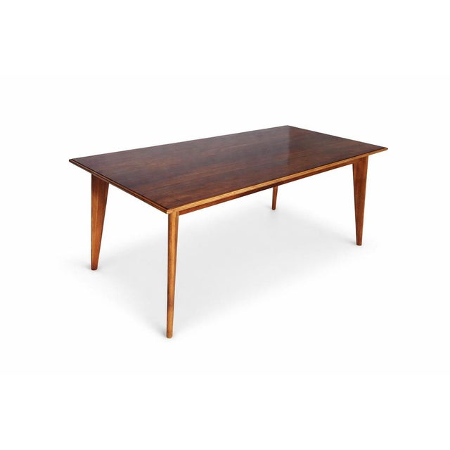A beautifully proportioned mid-century modern dining table by Morris of Glasgow, crafted in a striking combination of...