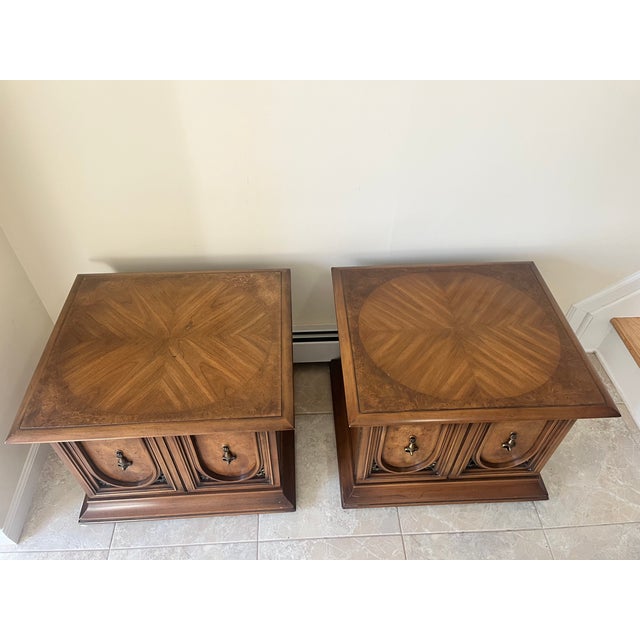 Sophisticated and stately, this exceptional pair of vintage commode-style end tables was produced in the 1960s by the...