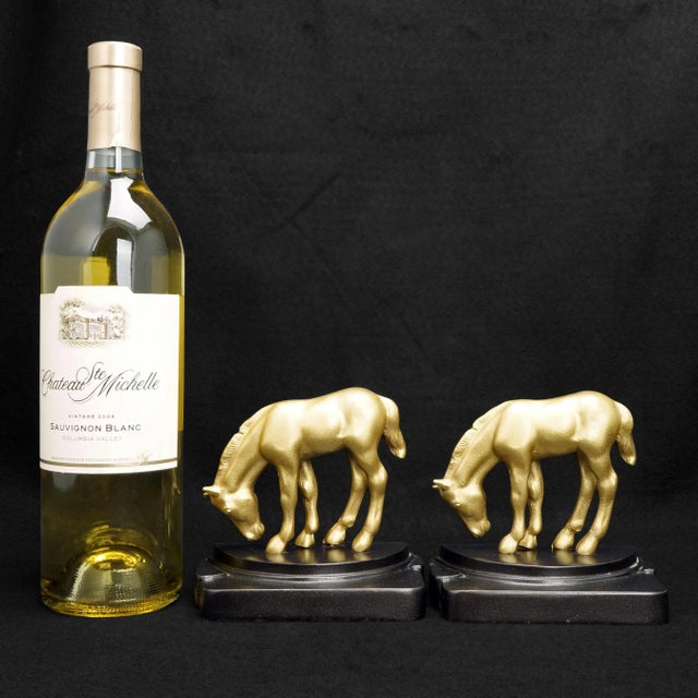 A golden pair of very Art Deco bookends that will light up a dark bookshelf. The cast gray metal pair of bookends golden...