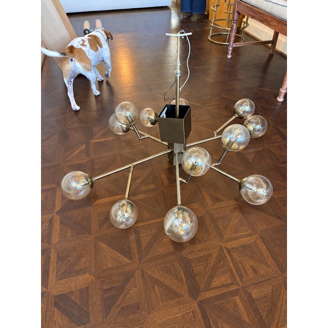Influenced by the 1970s space-race design, this sculptural chandelier lets you add a vintage industrial element to your...