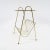 This magazine rack is formed by a brass frame and a perforated metal top. The frame is firm, some wear is present on the...