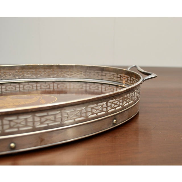 Early 20th century smaller inlaid mahogany serving tray under glass with silver plate gallery. Marked by the maker "Wilcox...