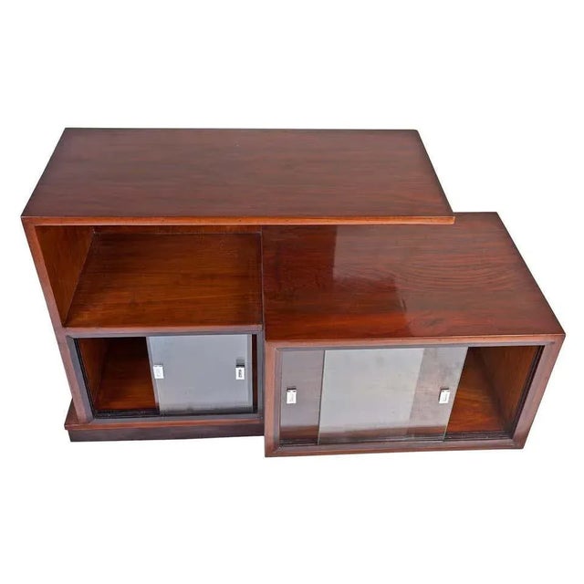 A multi-level mid-century modern teak wood credenza and shelves with sliding glass panels on the lower level. The left...