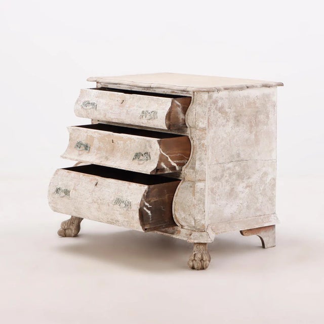 A Nineteenth Century Dutch bombay three drawer commode in bleached finish with claw feet.