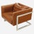 A vintage Cube club chIr designed by Milo Baughaen for Thayer Coggin. The caramel-colored leather chair features a chrome...