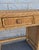 Vintage three-piece wicker vanity set, complete with an arched mirror and matching stool. The vanity features a woven...