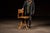 Solid wood drafting stool featuring a shaped plank seat and curved backrest mounted to an early iron swivel and height-...