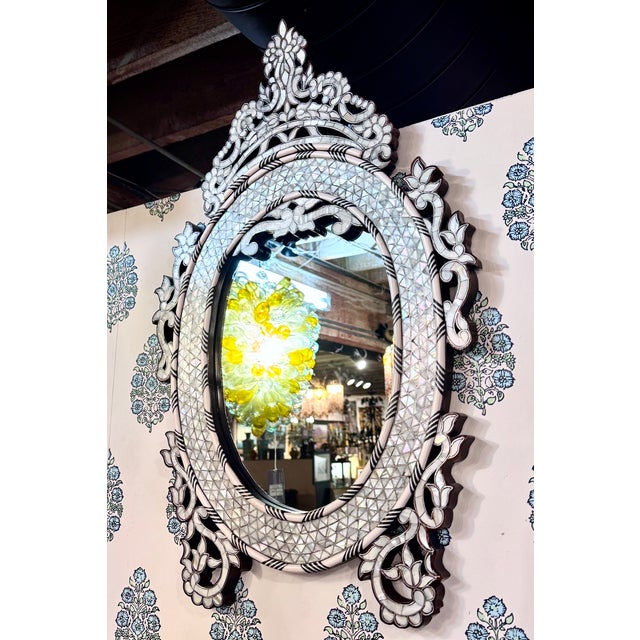 A rare and unusual find, this vintage handcrafted oval mirror features exquisite mother-of-pearl inlay set into natural...