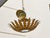 Radiating with sculptural flair, this Spanish gilt metal light fixture from circa 1950-1960 takes inspiration from...