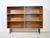 Minimalist mid-century shelving unit in teak veneer with black metal legs, 1960s. The open rectangular body is divided...