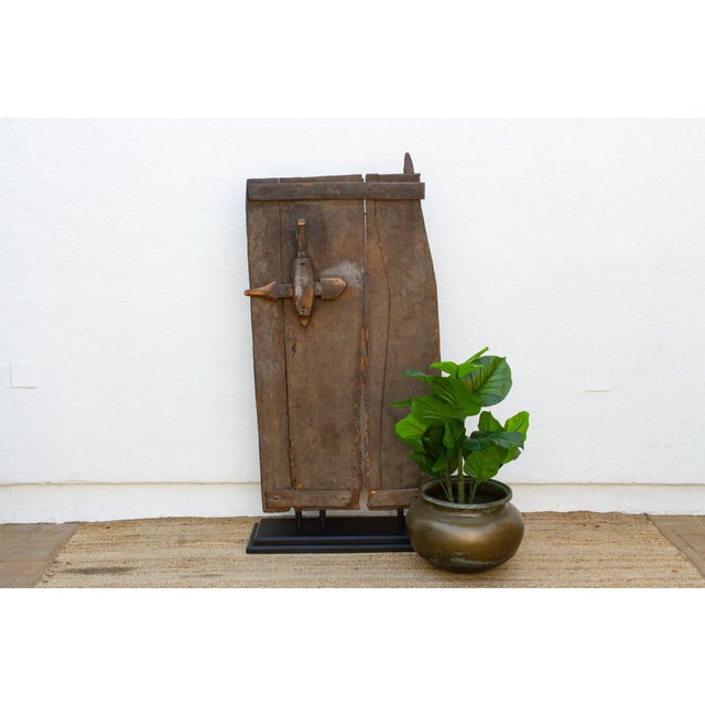 From the Bandiagara region of Mali, this two-plank granary door retains its original hand-carved wood lock, worked in a...