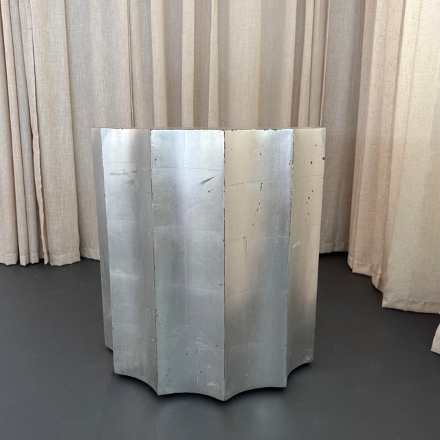 This sculptural, fluted Doric column drum table by The Sirmos Company, draws from classical architecture, executed with a...