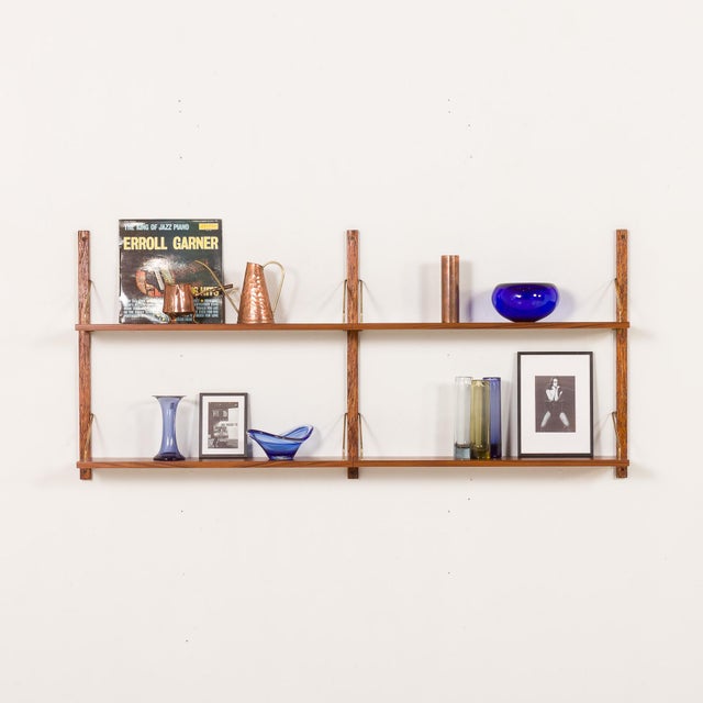 The minimalist Danish mid century upcycled teak shelving unit is a modular system with shelves arranged in two rows,...