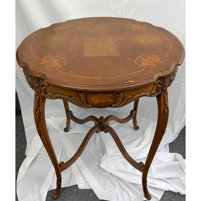 An antique Louis XV Revival parlor table by JB Van Sciver Co., circa 1900. Crafted in solid wood with elegant cabriole...