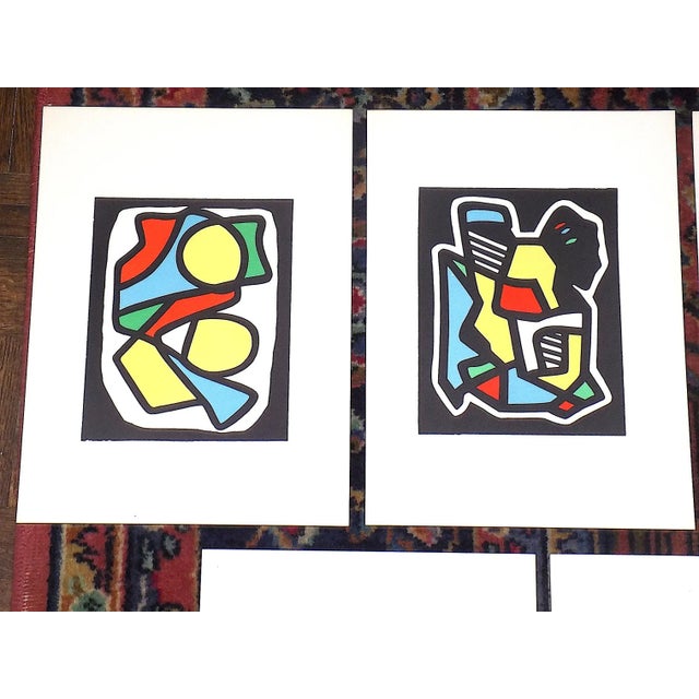 This set of nine (9) vibrant color lithographs (not offset lithographs) depict geometric abstractions from the portfolio...