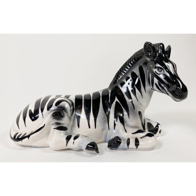 We're seeing stripes! There is nothing subtle about this striking vintage ceramic resting zebra figure. She shows...