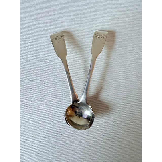 A pair of monogrammed antique sterling silver "Fiddleback" design salt spoons made by Thomas Johnson, a London-based...
