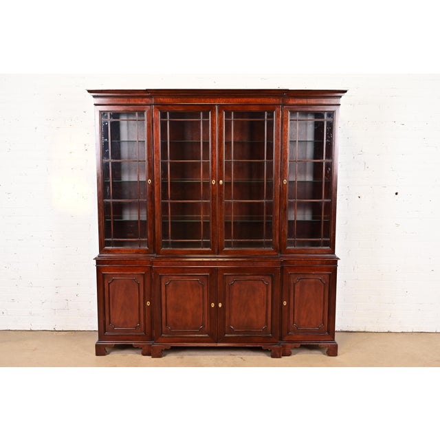 An outstanding Georgian or Chippendale style lighted breakfront bookcase cabinet or dining cabinet By Kindel Furniture...