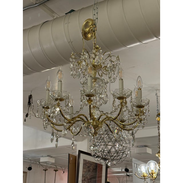 Design Plus Gallery presents a Crystal Chandelier with Vintage Appeal. The chandelier has a polished brass frame that...