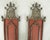 A pair of candle wall sconces with a lovely coral background The decoration is vaguely chinoiserie