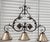 Large wrought iron and bronze accented chandelier pendant by Ironware International, Inc. The three lights volute...