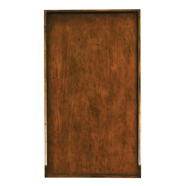 A handy table for drinks with a rectangular top over four square corner posts that flank three individual drawers....