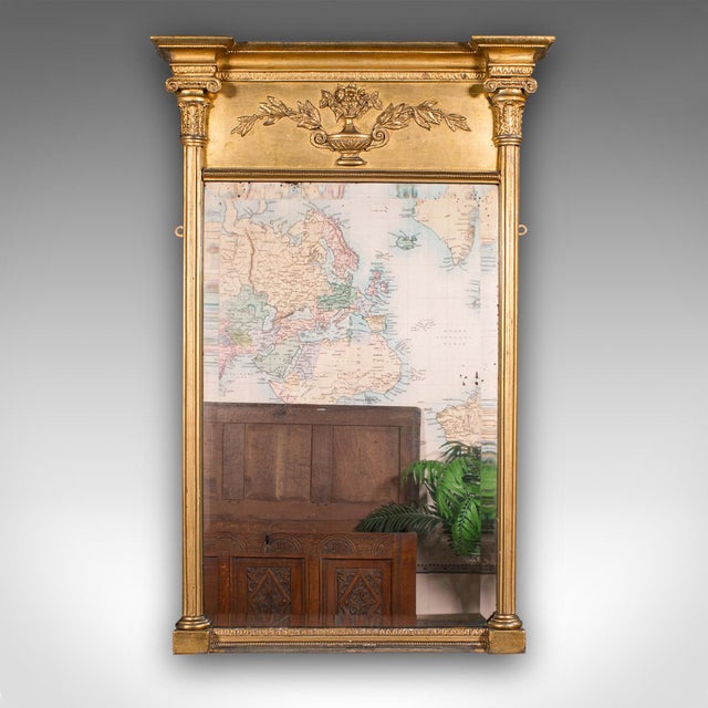 This is a tall antique pier mirror. An English, giltwood bevelled wall mirror, dating to the late Georgian period, circa...