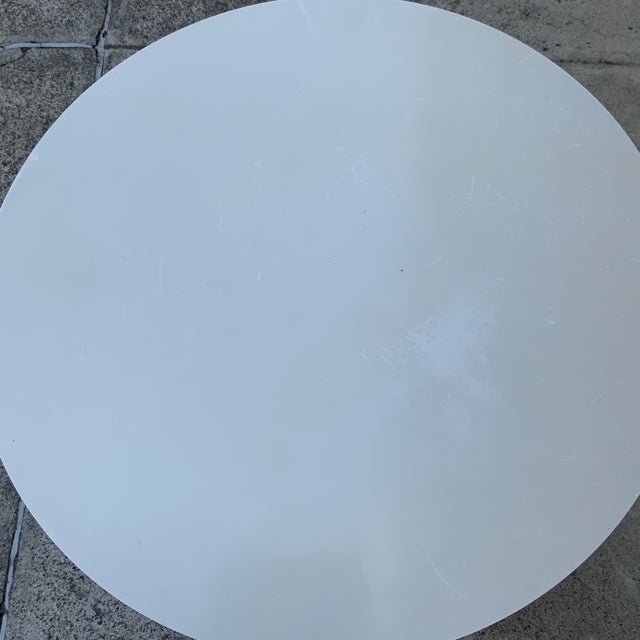 A diminutive pair of Saarinen-style small tulip side tables. I believe these are made similarly, with cast aluminum, but I...