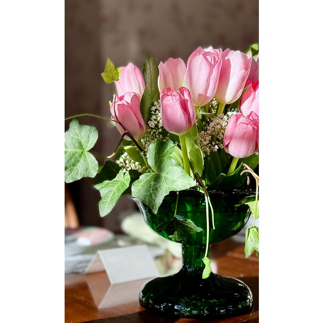 A striking late 19th century emerald green pressed glass compote with a deeply molded petal-form rim and sculptural...