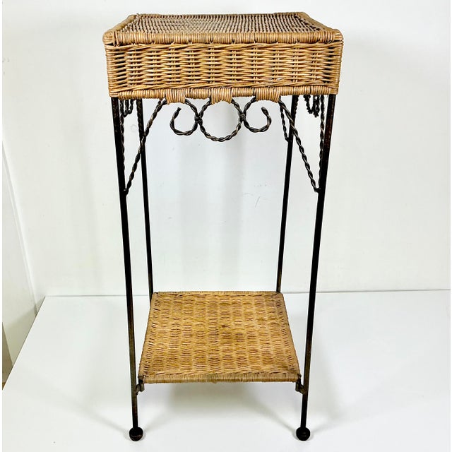 This wicker and metal Plant Stand from the 1980s features the iconic Mid-Century design element of twisted rope metal....