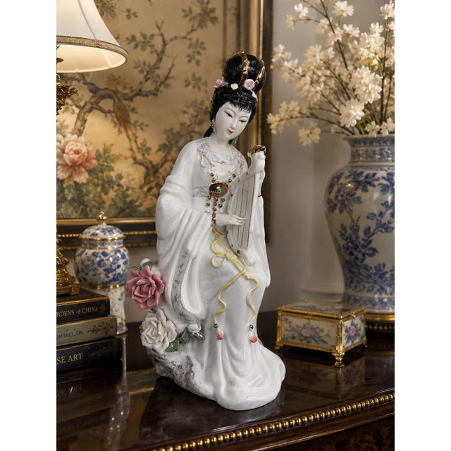 Elegant vintage Chinese porcelain court lady figurine depicting a gracefully seated musician holding a traditional...