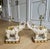 Charming pair of vintage Hollywood Regency elephant table lamps. These stately pieces feature a beautiful cream-white...