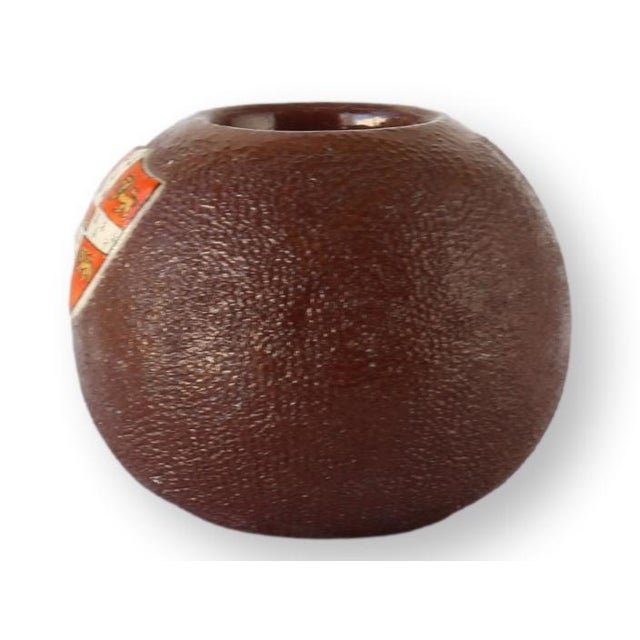 English Cambridge University match striker, redware pottery with textured surface and inset enamel crest. A collectible...