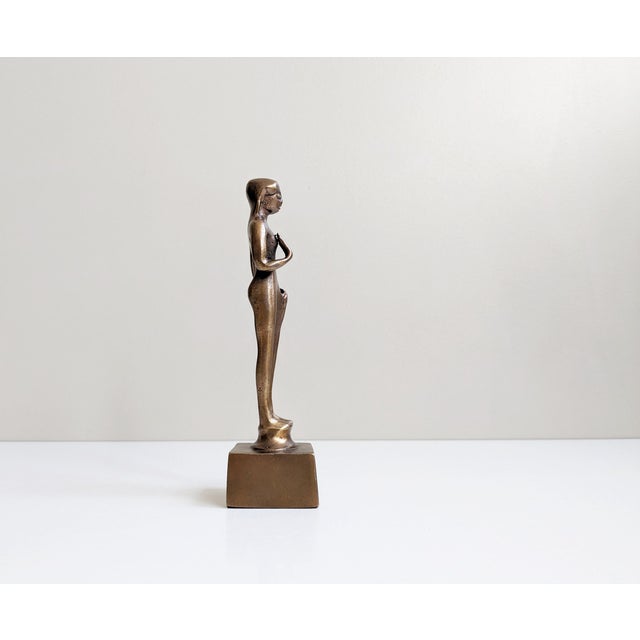 This bronze figure shows a standing woman and was designed based on old bronze works of art. The original bronze sculpture...