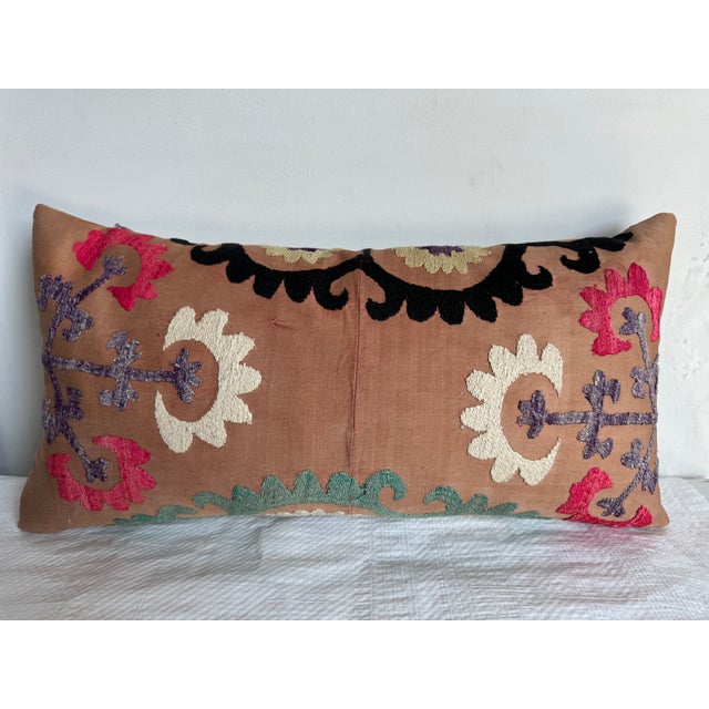 Add a touch of history and global charm to your space with this stunning 1900s Suzani pillow. Handcrafted with intricate...