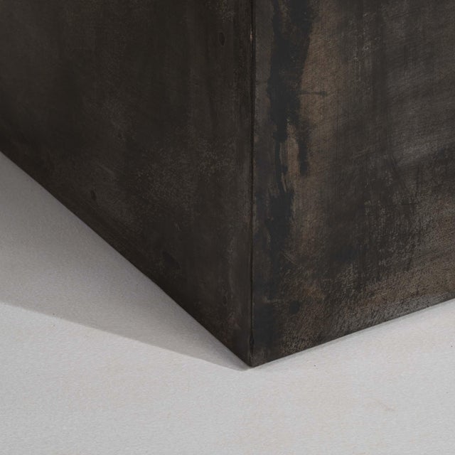 A bold French Brutalist table featuring an octagonal slate stone top supported by a strong iron base, emphasizing raw...