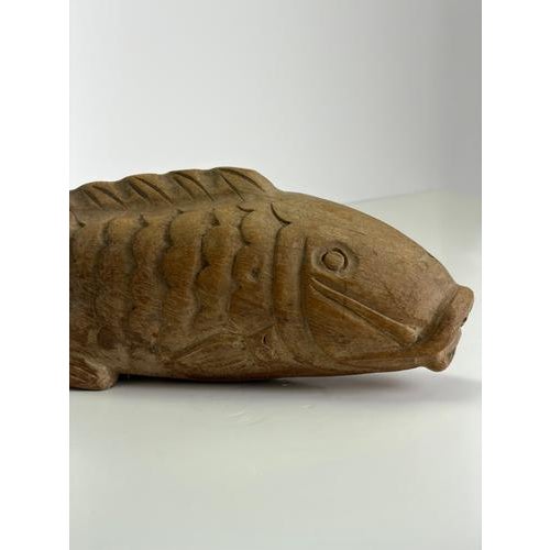 A large hand-carved Japanese koi carp sculpture in keyaki wood, dating to the late 19th century during the Meiji period....