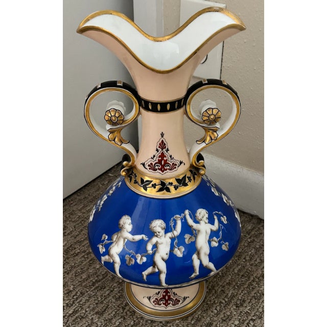 Up for sale is a Mid 19th Century French Rococo Revival Porcelain Hand-Painted Gilded Bacchanal Putti Holding Vine Motif...
