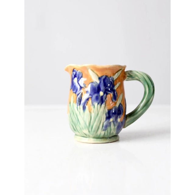 A vintage ceramic creamer, dating to the early to mid-20th century, in a charming Italian-inspired style. The piece...