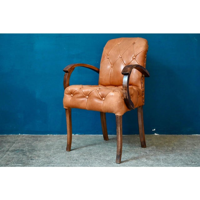 Natural elegance, an inviting silhouette, and guaranteed comfort define this magnificent bridge chair, a French Art Deco...