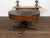 An English Regency period mahogany drum or rent table from the early 19th century, with black leather top, eight drawers,...