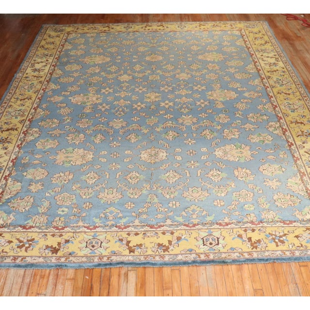 Large Antique Turkish Oushak rug in blue and mustard from the 1930s