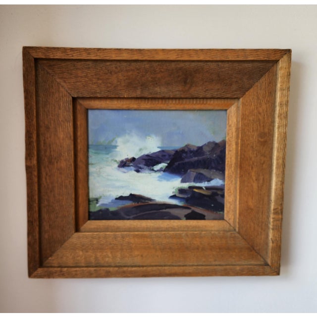 This 1938 oil painting on board by artist Arthur J. Hammond captures a moody seaside scene of waves crashing against...