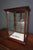 This antique chocolate display cabinet is made from mahogany and glass with gold leaf lettering. At the top, the lettering...