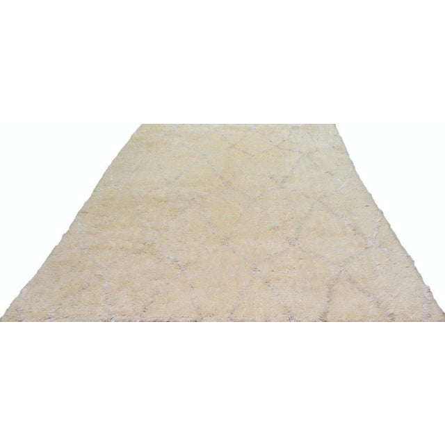 Hand-knotted with care using traditional rug-making techniques, this wool rug blends timeless craftsmanship with a modern...